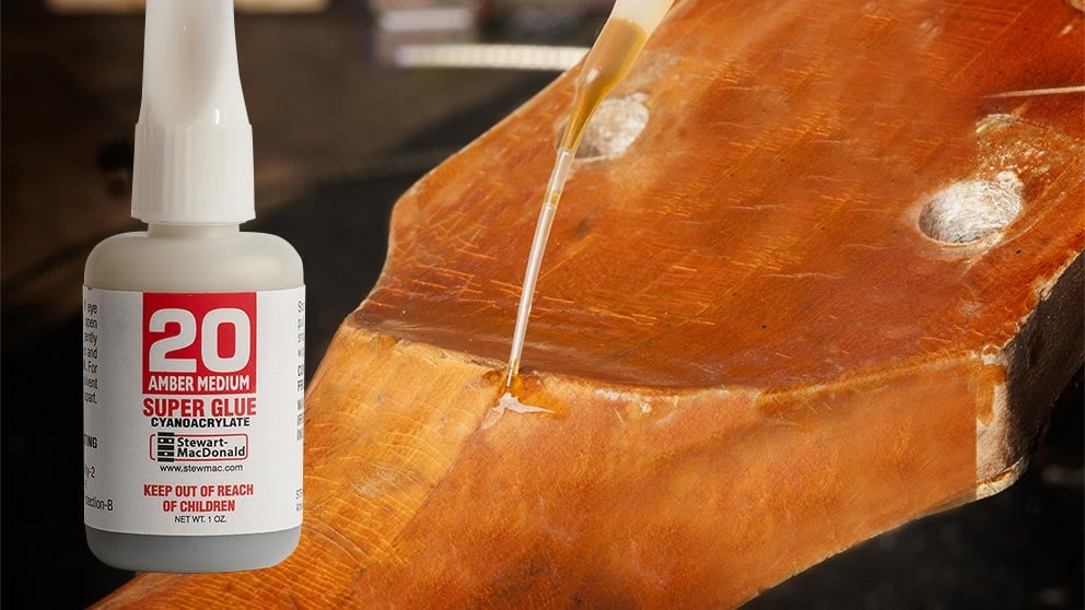 Chip de laca en un mástil de guitarra vintage relleno con super glue tintado en ámbar.