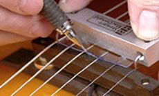 Filing E string slots