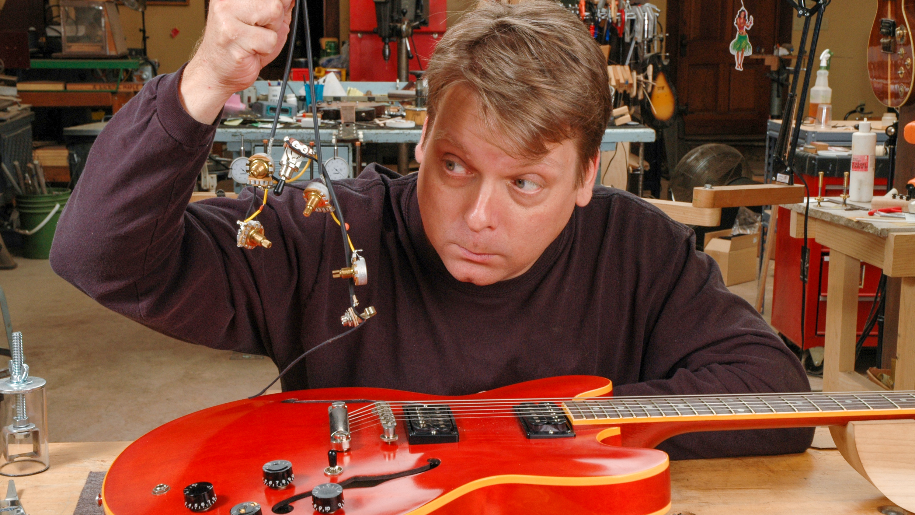 Fishing a volume control out of a semi-hollowbody for soldering.