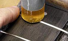 Hammering frets with a fret hammer