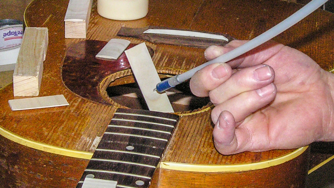 How would you reach inside a guitar to do this gluing?
