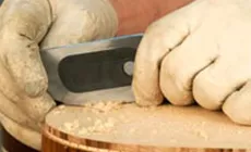 Sostenga el rascador casi vertical mientras lo empuja con los pulgares.