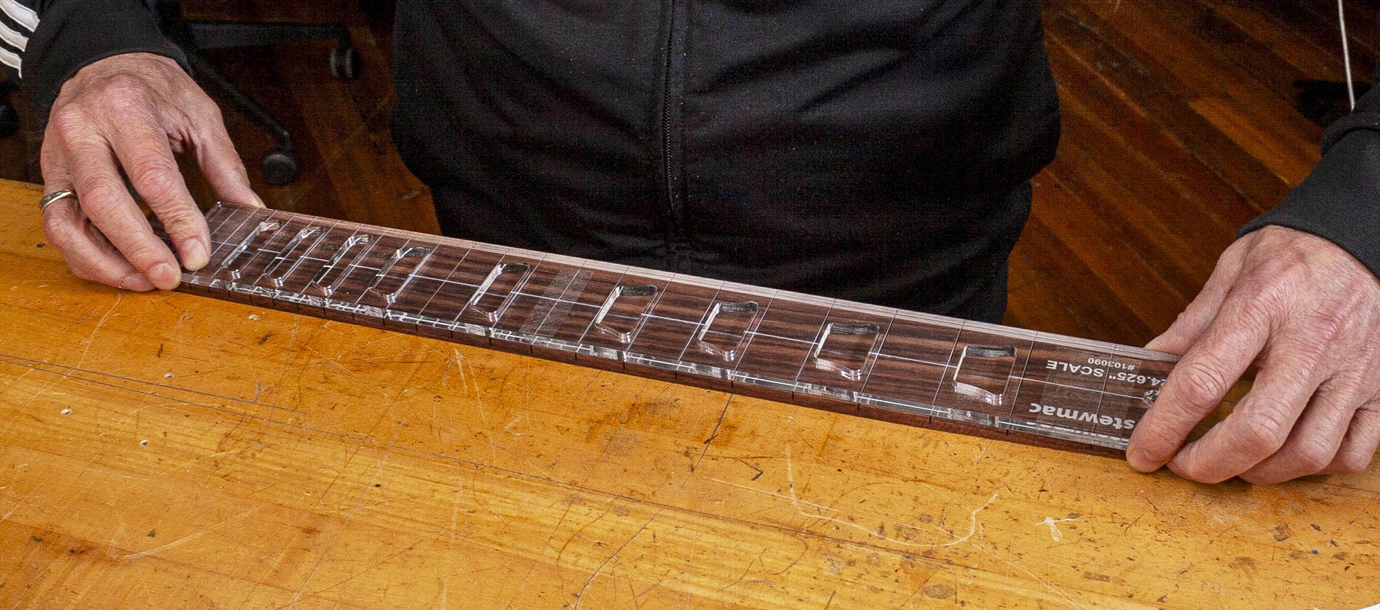 Alinee la plantilla de incrustación con el diapasón.